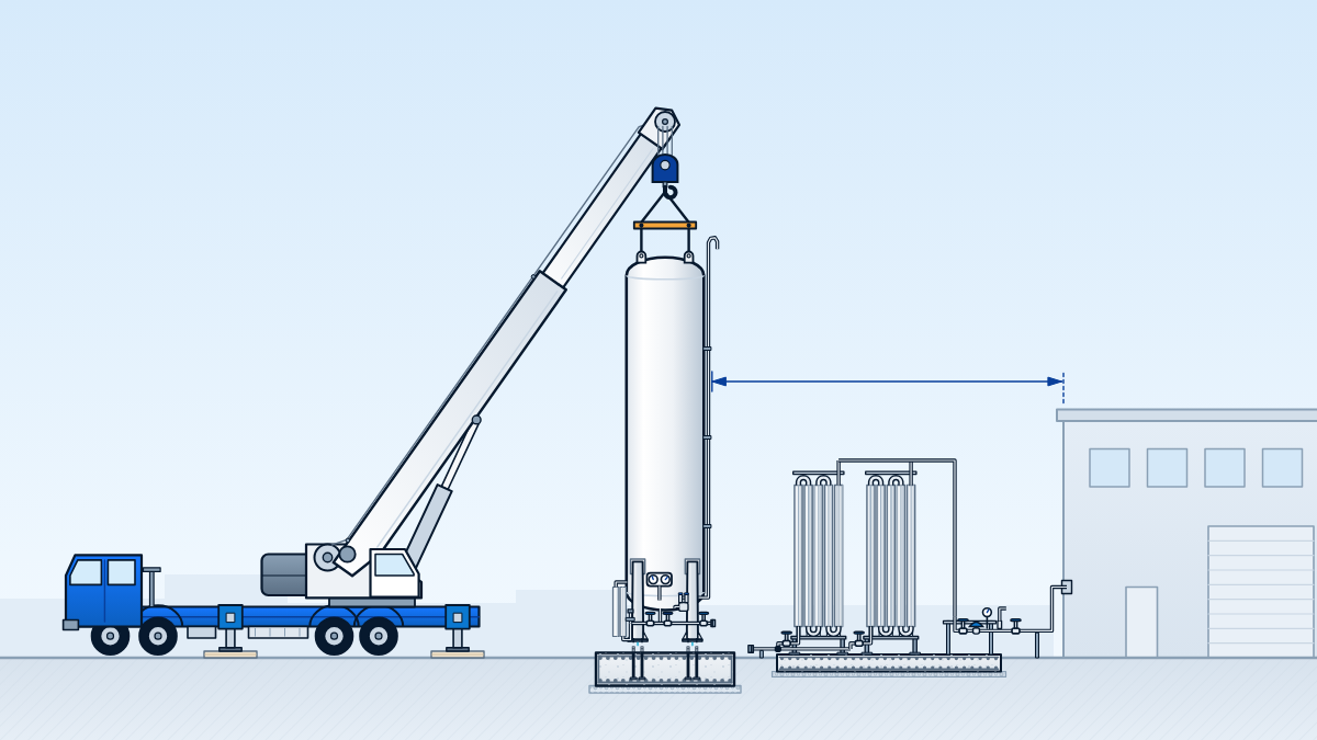 Erection day: a truck crane on outriggers lifting a 25,000-litre vertical tank onto its foundation bolts, with the pad and ground cut away