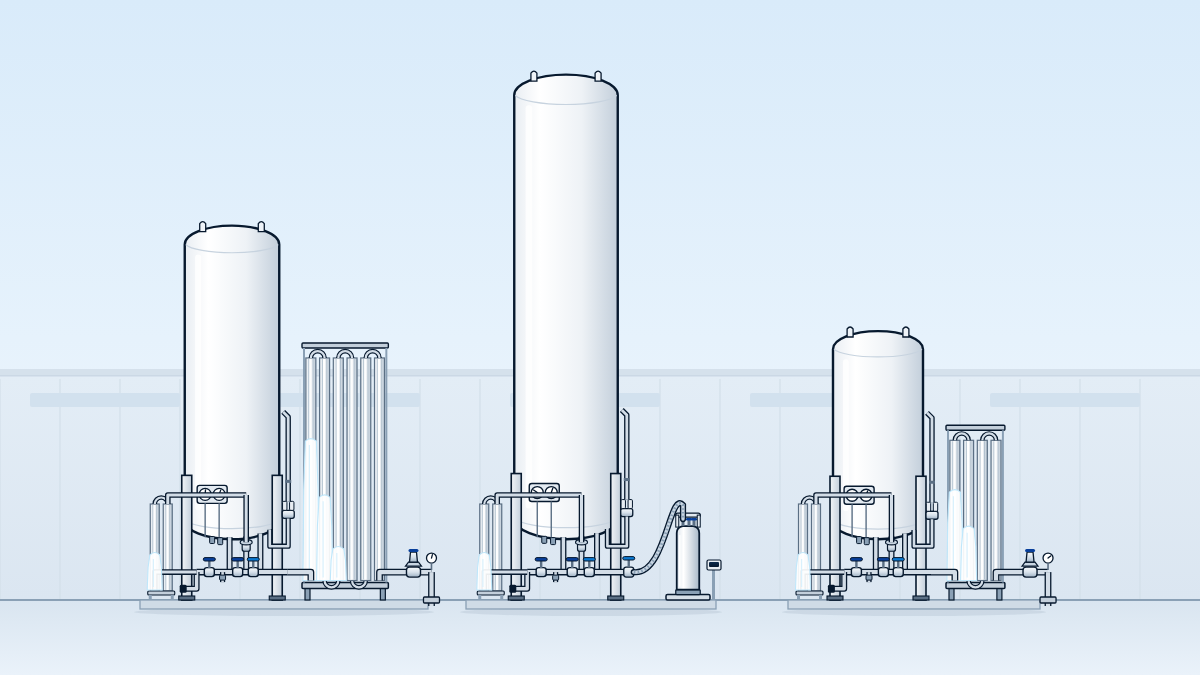 Tank yard with three white vertical cryogenic storage tanks of different sizes at true relative scale, each with its own valve cluster and pressure-building coil