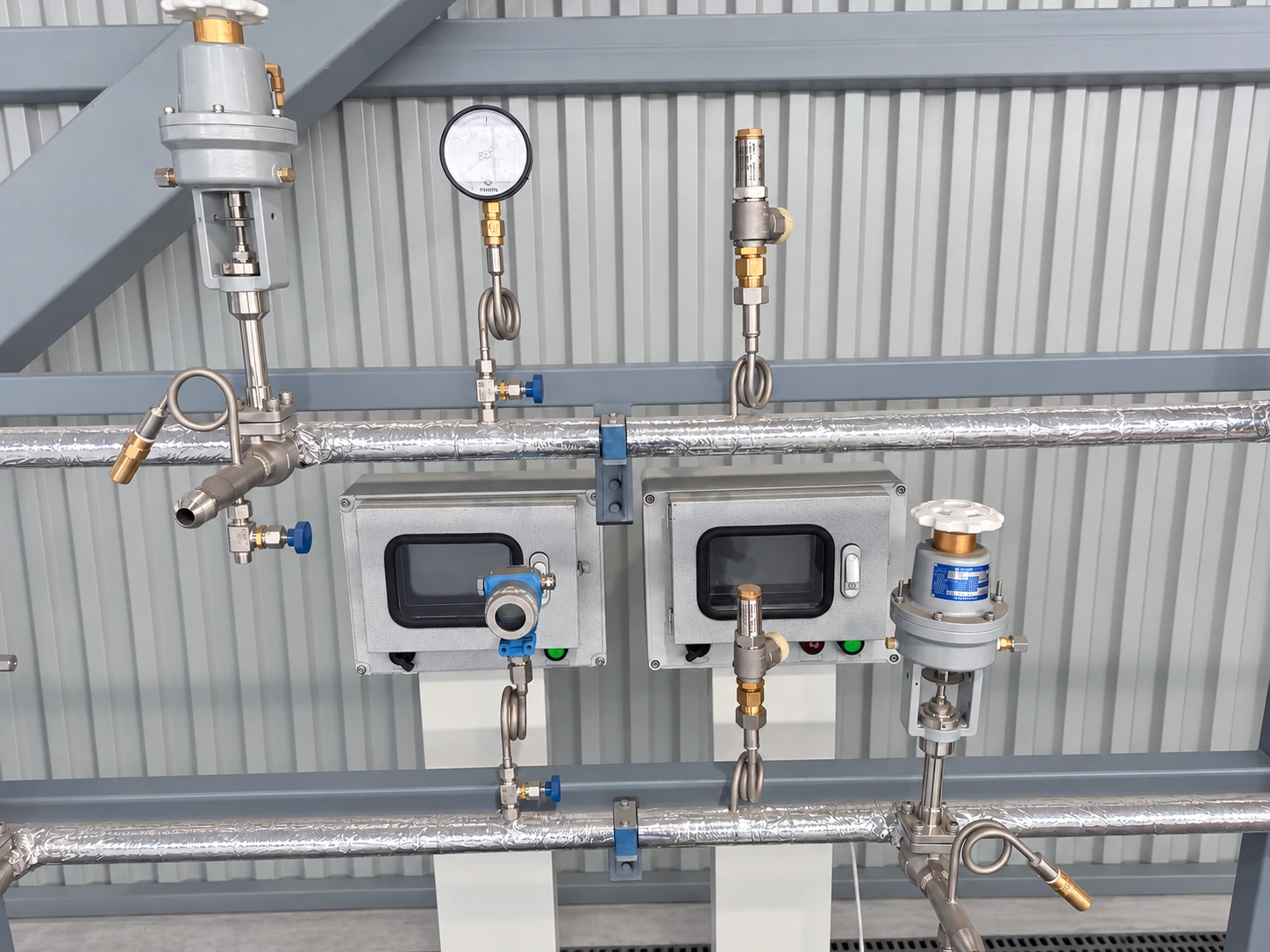 Filling station detail with two control units, insulated pipework, valve assemblies and instruments